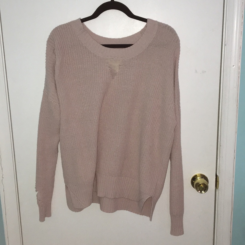 Pink distressed sweater.